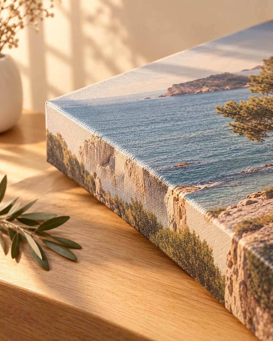 Detalle de un lienzo con una cala mediterránea, con el borde tensado sobre el bastidor